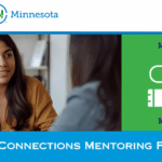 The Career Connections Mentoring Program 2026 Banner with the Disability:IN Minnesota logo, and tagline “Your Business partner for disability inclusion” to the top left, and 2026 in blue to the right. Below is a woman with long, dark hair, and wearing a brown shirt. She is smiling, looking across the desk, and actively engaged in a conversation with a person sitting in front of her. She has a laptop in front of her, but to left side of the picture. To the right of this picture is a green rectangle with a white graphic representing the connection between a mentee and a mentor using two plugs connected by a winding cord. The words "Mentee" and "Mentor" are placed above and below the respective "plug" symbols. At the bottom of the image in white are the words Career Connections Mentoring Program.